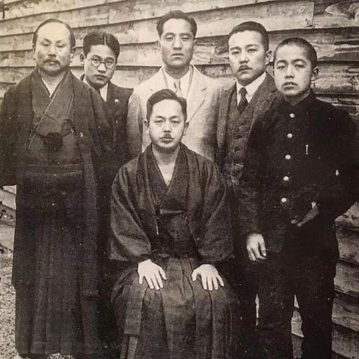 From left to right: Funakoshi Gichin, Nakasone Genwa, Ōtsuka Hironori, Yasuhiro Konishi and Mabuni Ken'ei; Mabuni Kenwa (on chair).